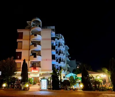a large building with a clock tower at night at The Love Nest - 1BD Apartment in Sunny Beach by Flat Mаnаger in Sunny Beach