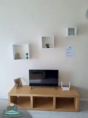 a flat screen tv sitting on top of a wooden table at Studio Demokratsia in Burgas City