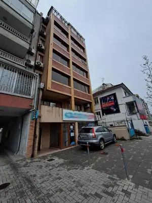 a car parked in a parking lot in front of a building at Studio Demokratsia in Burgas City