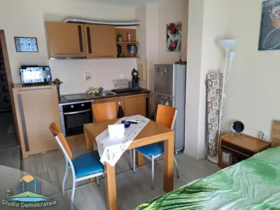 a small kitchen and dining room with a table and chairs at Studio Demokratsia in Burgas City