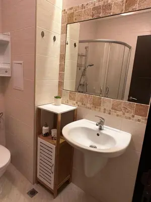 a bathroom with a sink and a mirror and a toilet at Apartament CASCADAS FAMILY in Sunny Beach