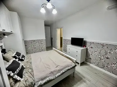 a bedroom with a bed and a tv in it at Sea angel in Burgas City
