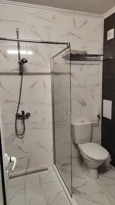 a bathroom with a toilet and a glass shower at Sea angel in Burgas City