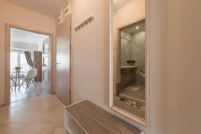 a hallway with a mirror on the wall at Casa de la playa in Varna City
