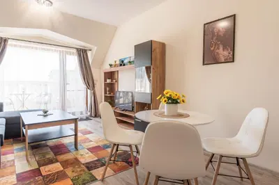 a living room with a table and chairs at Casa de la playa in Varna City
