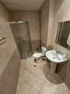 a bathroom with a shower and a toilet and a sink at VV Vigo Apartments in Nesebar