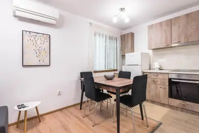 a kitchen with a table and chairs in a room at Peaceful Central Place - Vazov street in Varna City