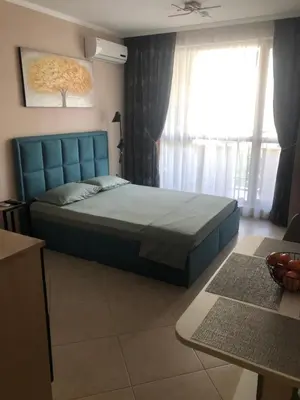 a bedroom with a blue bed and a window at Private Studio Sunny Beach- Cascadas in Sunny Beach