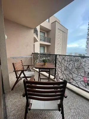 a balcony with two chairs and a table on a balcony at Royal Beach NICE VIEW in Sunny Beach