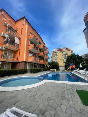 a building with a swimming pool in front of a building at A Tiny Flat in Sunny Beach