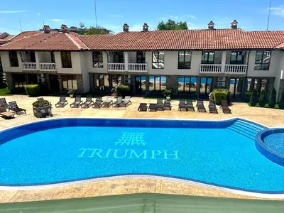 a large swimming pool in front of a hotel at Apartment Marina beach k-s Triumph in Sveti Vlas