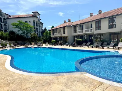 a large blue swimming pool in front of some buildings at Apartment Marina beach k-s Triumph in Sveti Vlas