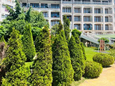 a group of trees in front of a building at Apartment Marina beach k-s Triumph in Sveti Vlas