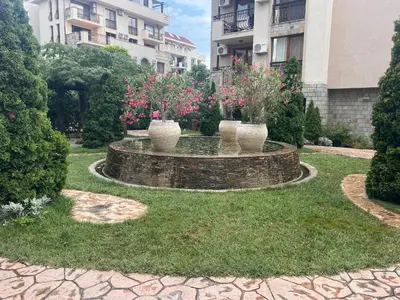 a garden with three vases with flowers in it at Deluxe Appartements in Cascadas Family Resort Sunny Beach in Sunny Beach