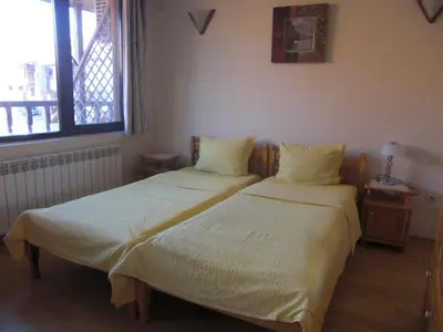 two beds sitting next to each other in a bedroom at Guest House Antoaneta in Nesebar