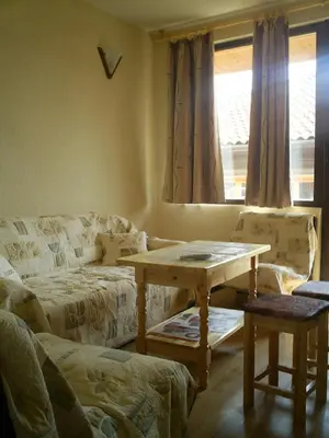 a living room with a table and a couch at Guest House Antoaneta in Nesebar