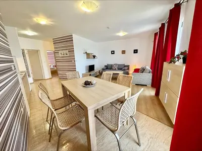 a living room with a table and chairs at Sea View Apartments - Aheloy in Ravda