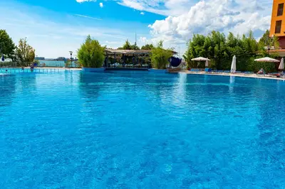 a large swimming pool with blue water at Sea View Apartments - Aheloy in Ravda