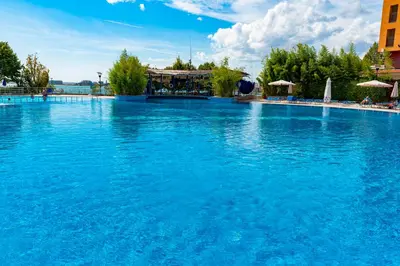 a large swimming pool with blue water at Sea View Apartments - Aheloy in Ravda