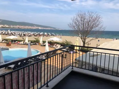 a balcony of a resort with a swimming pool and a beach at SEAVIEW Heaven Sunny Beach in Sunny Beach
