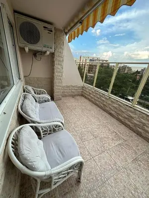 a balcony with two beds and a air conditioner at Central, 3 Bedroom Apartment at Golden Fort Complex in Sunny Beach
