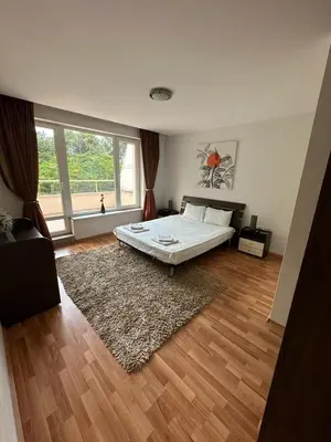 a bedroom with a bed and a large window at Central, 3 Bedroom Apartment at Golden Fort Complex in Sunny Beach