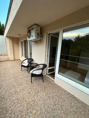 a patio with two chairs and a table on a house at Central, 3 Bedroom Apartment at Golden Fort Complex in Sunny Beach