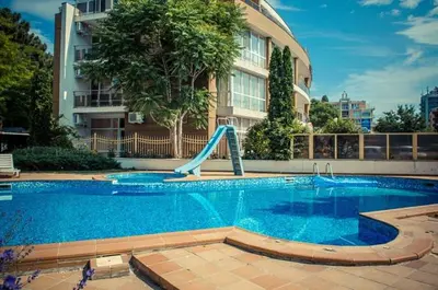a swimming pool with a slide in front of a building at Central, 3 Bedroom Apartment at Golden Fort Complex in Sunny Beach