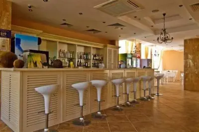 a row of stools at a bar in a restaurant at Spacious, 1 Bed Apt, Dawn Park in Sunny Beach