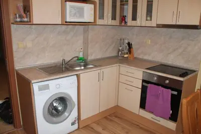 a kitchen with a sink and a washing machine at Spacious, 1 Bed Apt, Dawn Park in Sunny Beach