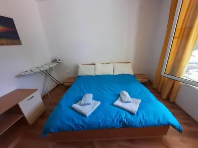 a bedroom with a blue bed with two towels on it at Central, 1 Bed Apt, 3* Yassen in Sunny Beach