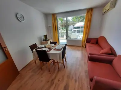 a living room with a table and a couch at Central, 1 Bed Apt, 3* Yassen in Sunny Beach