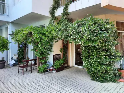 a building with two arches covered in plants at Central, 1 Bed Apt, 3* Yassen in Sunny Beach