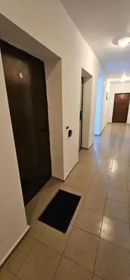 an empty hallway with a black door and a tile floor at Studio Nina in Primorsko