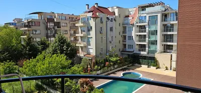 a balcony with a swimming pool and buildings at Studio Nina in Primorsko