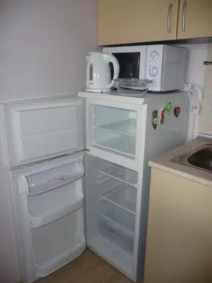 a kitchen with a white refrigerator with its door open at Great Choice Apartment in Chernomorets