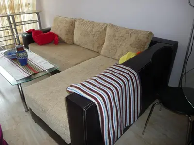 a living room with a couch and a table at Great Choice Apartment in Chernomorets