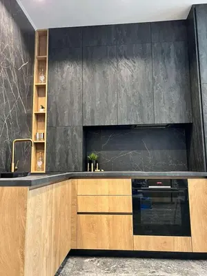 a kitchen with wooden cabinets and a black wall at Villas Park Lozenets in Lozenets