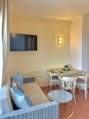 a living room with a couch and a table at SH Holidays & Health Beach-Apartments in Sozopol