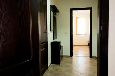 an empty hallway with a door and a window at Ivatea Family Hotel in Ravda