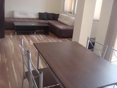 a living room with a table and a couch at Ivatea Family Hotel in Ravda