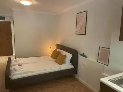 a bedroom with a bed in a room with a sink at Santa Marina Holiday Village Studio Iskra in Sozopol