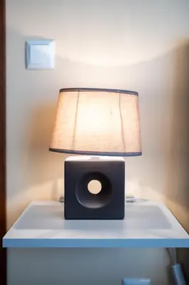 a lamp on a table with a speaker on it at Brand New Downtown Apartment in Varna City