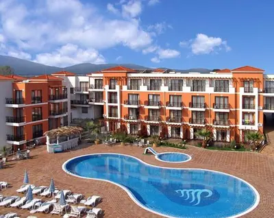 a hotel with a swimming pool and chairs and umbrellas at Hotel Paradise Garden in Chernomorets