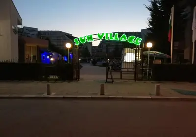 a neon sign that says sun village on a street at Kims One-bed Apart for rent at Sunny Beach Resort in Sunny Beach