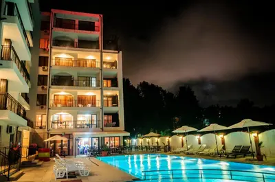 a hotel with a swimming pool in front of a building at Cantilena Complex in Sunny Beach