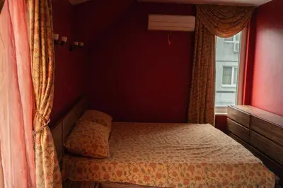 a small bedroom with a bed and a window at Aпартамент в близост до морето и центъра in Burgas City