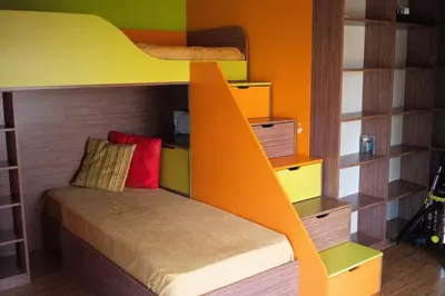 a bedroom with a bunk bed with an orange ladder at Aпартамент в близост до морето и центъра in Burgas City