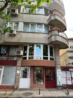 a tall building with a balcony on top of it at Център Варна апартамент с паркинг за нормална до средно голяма кола in Varna City