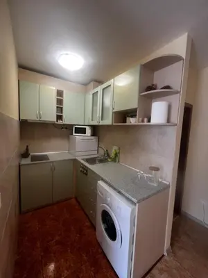 a small kitchen with a washing machine in it at Elit 4 Apartments in Sunny Beach